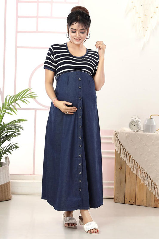 A pregnant woman wearing a dark blue maxi feeding dress with a striped knit fabric at the empire line and hidden zippers on the sides.